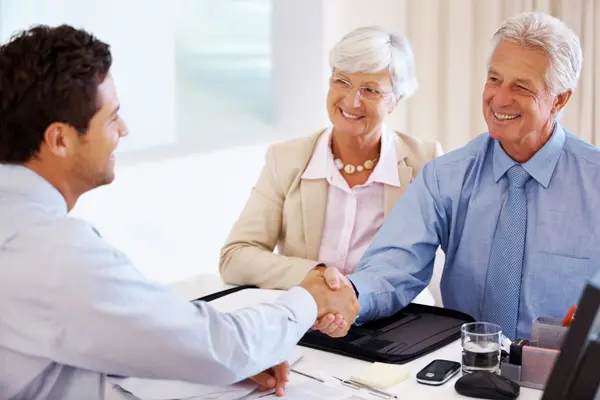 Doctor shaking hands with patients who were referred