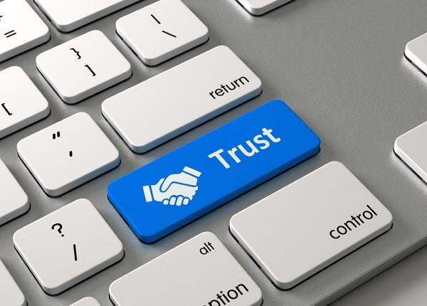 Blue trust key with image of a handshake on a keyboard