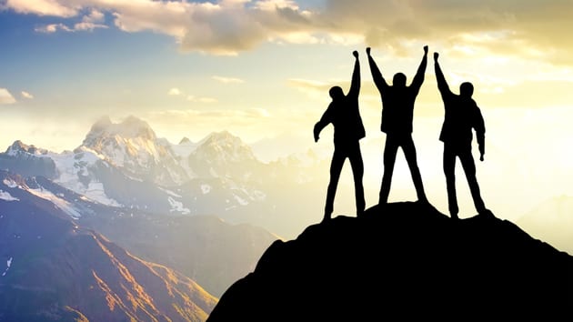 Picture of triumph on a mountaintop to represent making the ascent from brand challenger to brand leader (healthcare marketing)