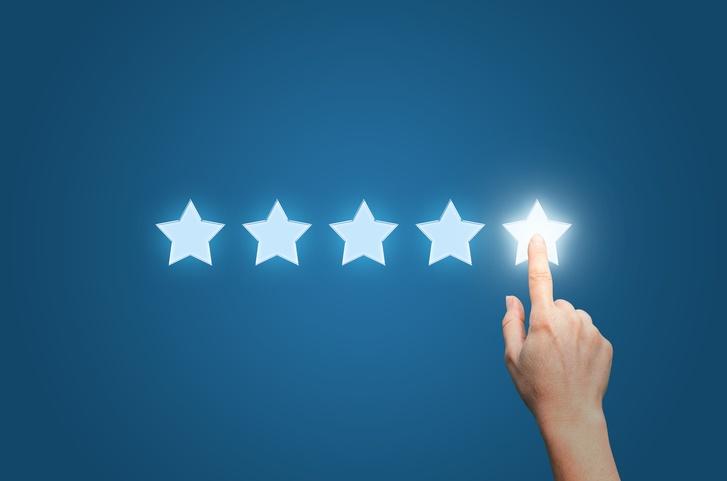 Medical professional pointing to five star to increase