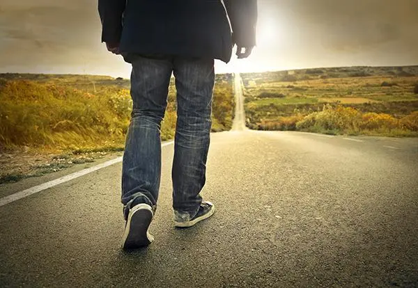 person walking down the empty road