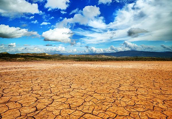 Draught in desert with cloudy sky