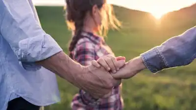 A sunkissed image of a family in a rural landscape.