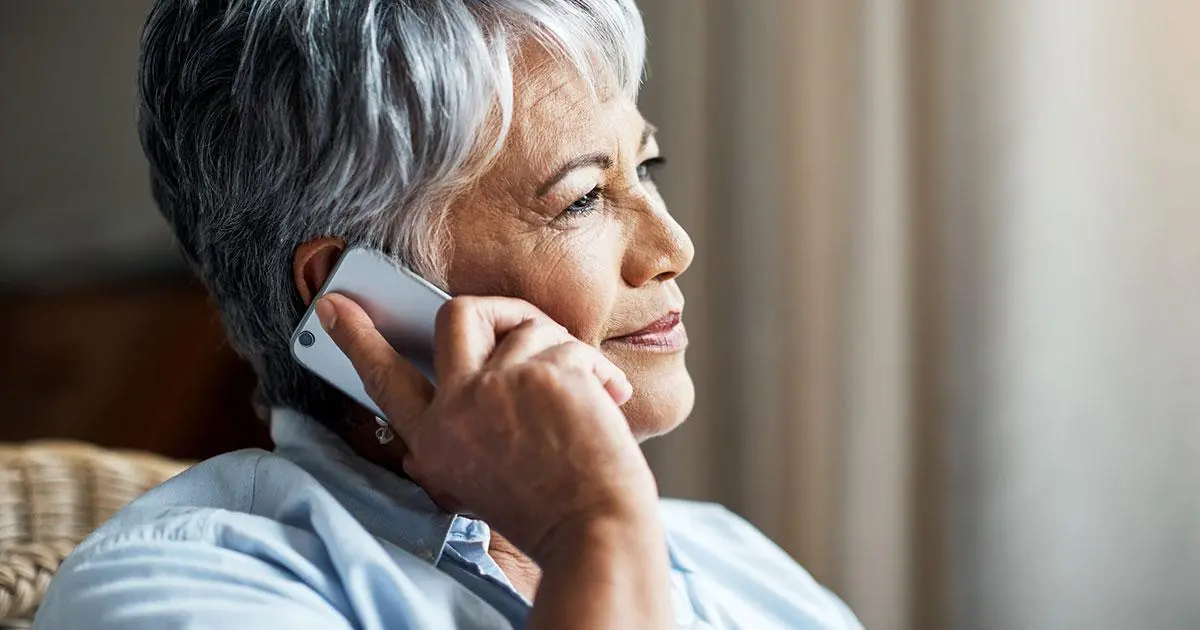 Woman on the phone calling her Audiologist after reading a positive review.