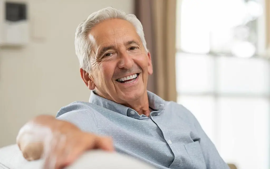 Happy senior getting hearing aids through Medicare.