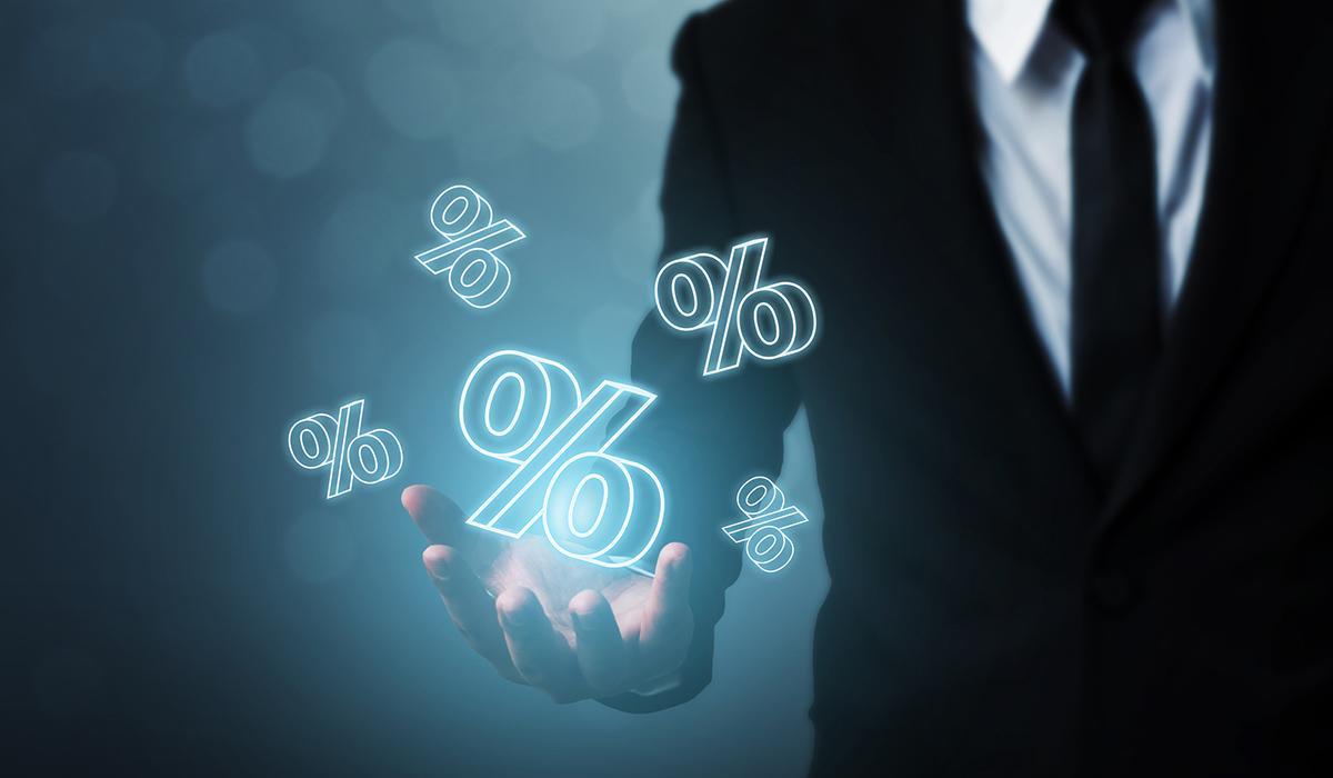 Man with percentages floating above his hand representing the increasing of acceptance rates in financing.