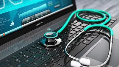 An image of a doctor’s stethoscope on a laptop to signify tracking technologies and the risk of patient data breaches.