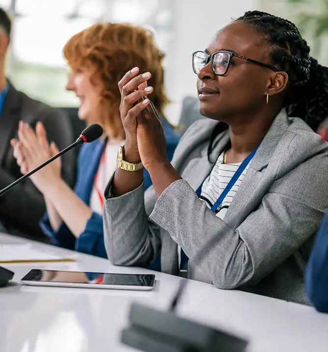 board members sitting at a table clapping