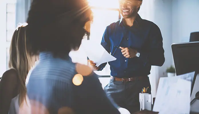 man presenting to two female coworkers