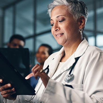 Doctor, mature woman with tablet