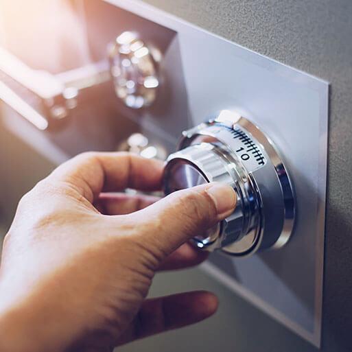 Close up of a man hand hold and tuning on a combinations safe dial lock