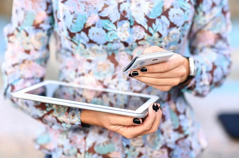 Young businesswoman working with modern devices, digital tablet computer and mobile phone.