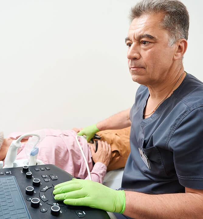 doctor examining man's abdomen