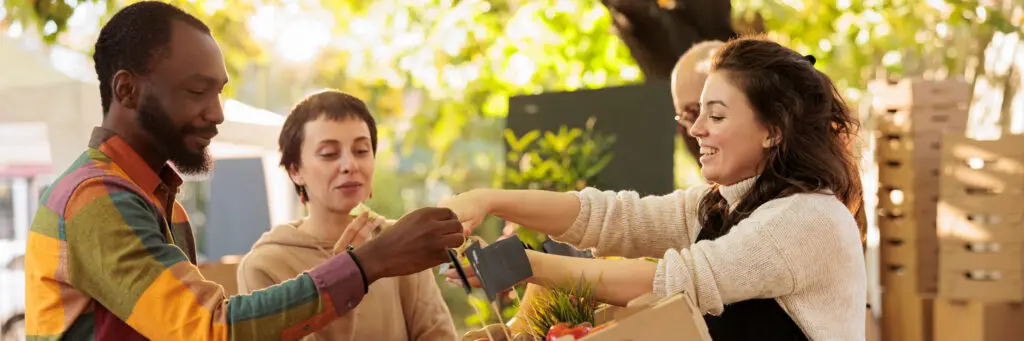 People at small fruit stand