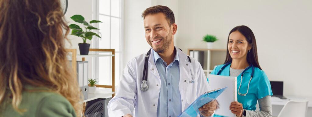 Doctor and nurse talking with patient