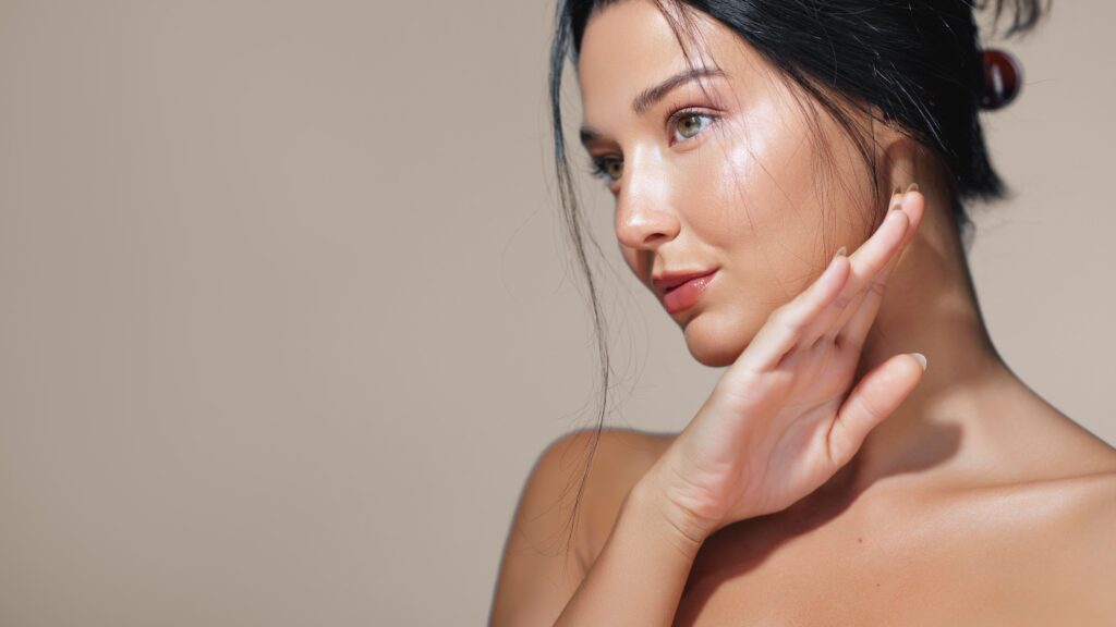 A woman looking away from the camera, representing how aesthetics and dermatology practices can set themselves apart in a saturated market.