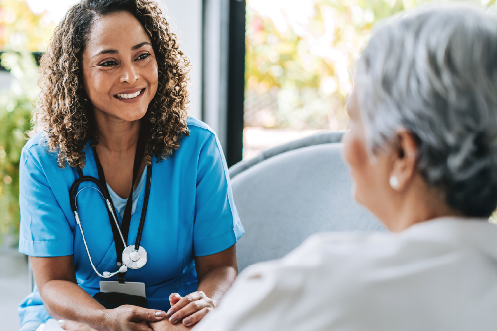 A female healthcare provider speaks with a patient.
