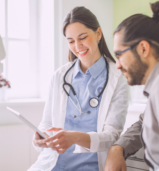 doctor and patient looking at a tablet