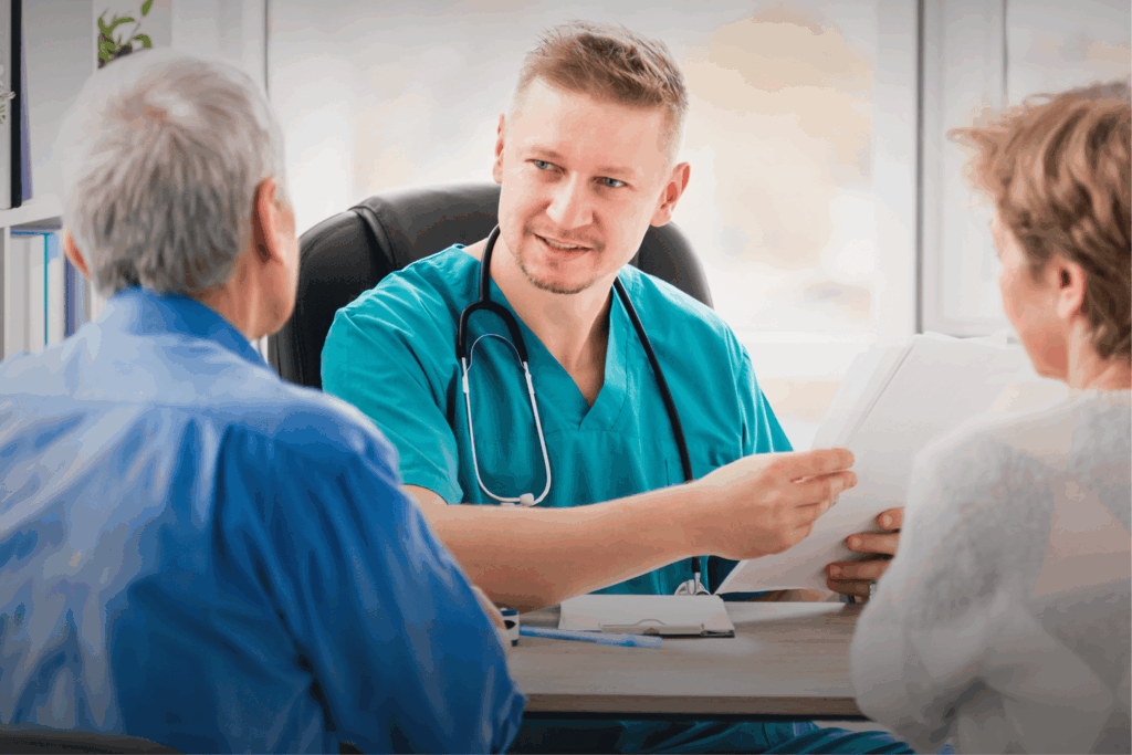 A couple consults a doctor in an outpatient setting.