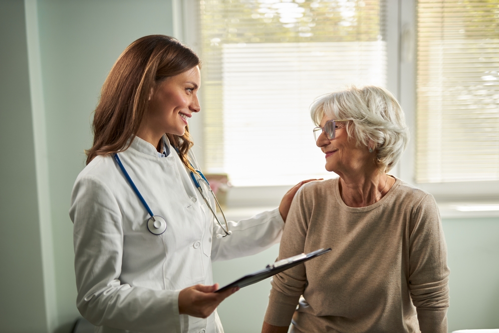 Female Doctor talking with Female elderly Patient