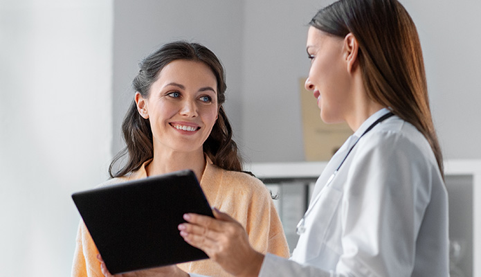 woman and her doctor looking at a tablet