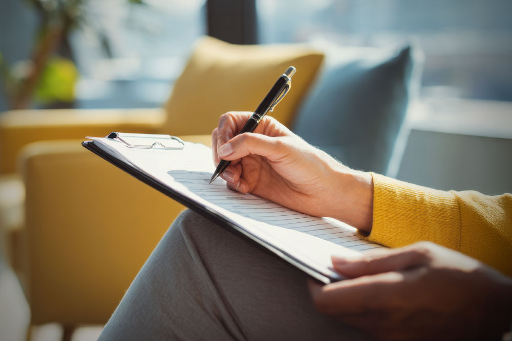 woman filling out a form on a clipboard