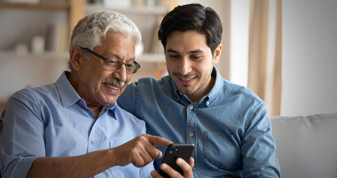 father and son looking at a phone
